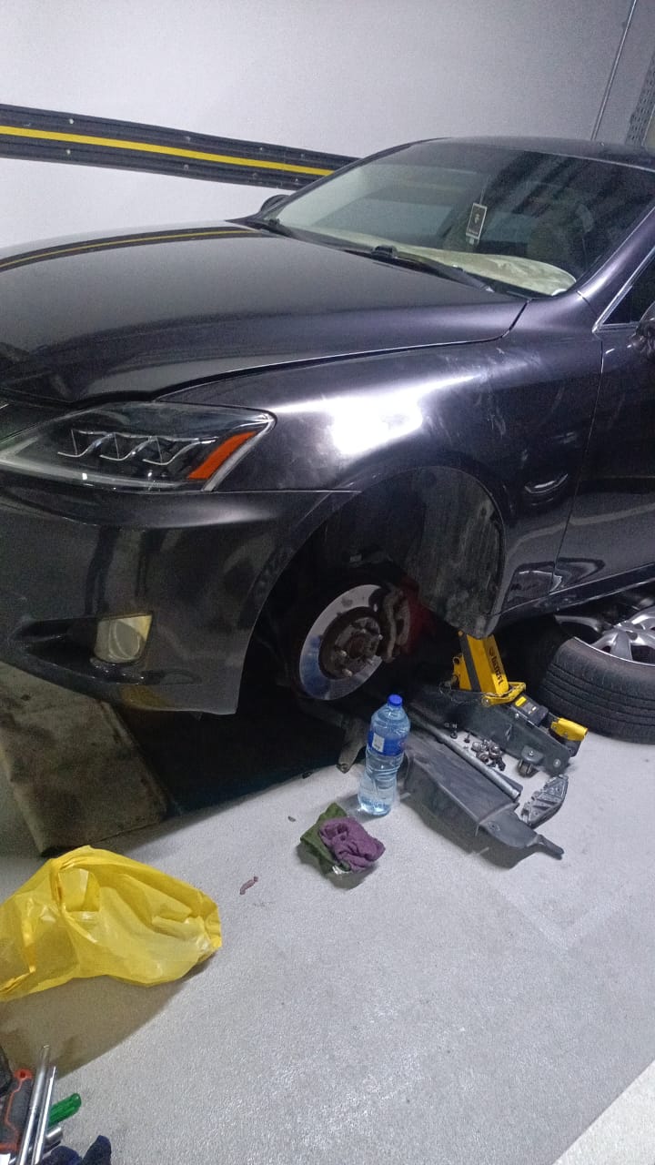 Technician replacing car brake pads during brake service