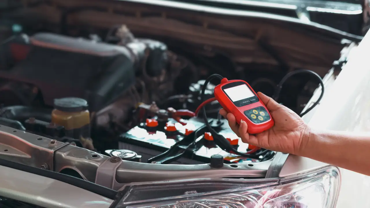 Mechanic using diagnostic scanner for emergency car repair in Dubai