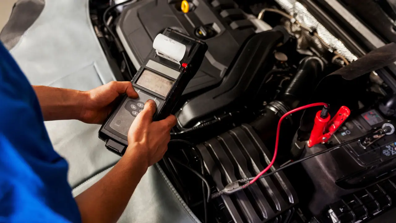Car mechanic checking engine diagnostics for professional car maintenance service in Dubai