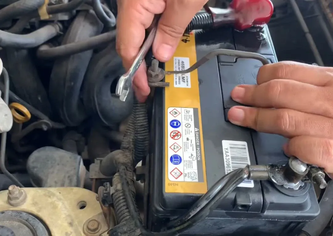 Technician installing a car battery during mobile battery replacement service